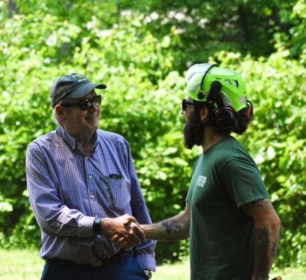 Teachers Tree Service arborist shaking hands with a satisfied customer