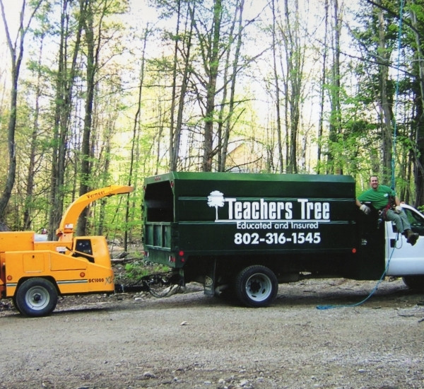 Teachers Tree Service chipper truck and wood chipper staged at a job site